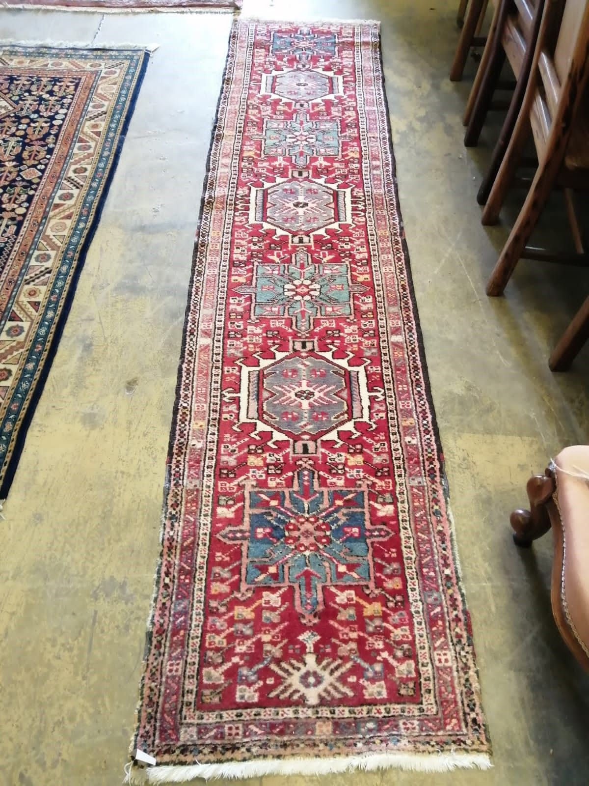 A Caucasian red ground runner, 296 x 64cm